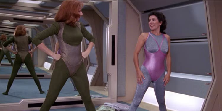 Beverly Crusher exercising in Starfleet workout attire.