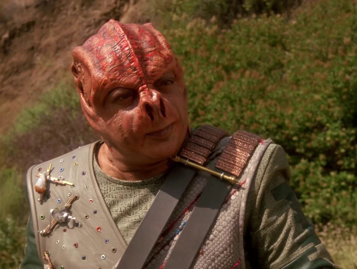 A Tamarian officer facing forward on the bridge of a Tamarian vessel.