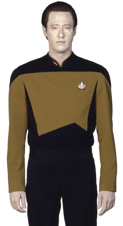 Lieutenant Commander Data standing in his gold and black Starfleet operations uniform.