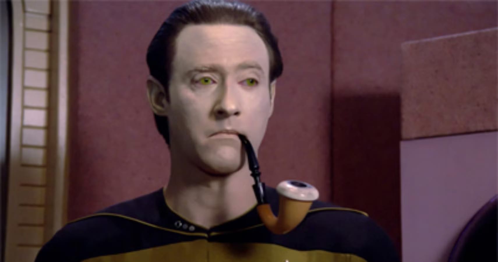Data holding a pipe while participating in a Sherlock Holmes holodeck program.