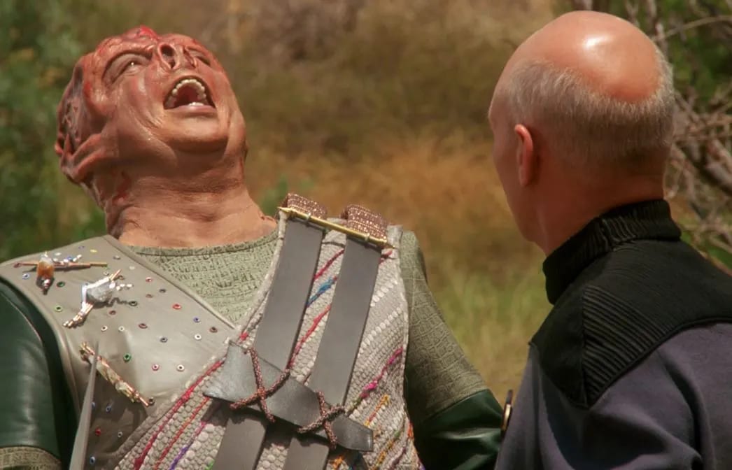 Dathon laughing during his encounter with Jean-Luc Picard.