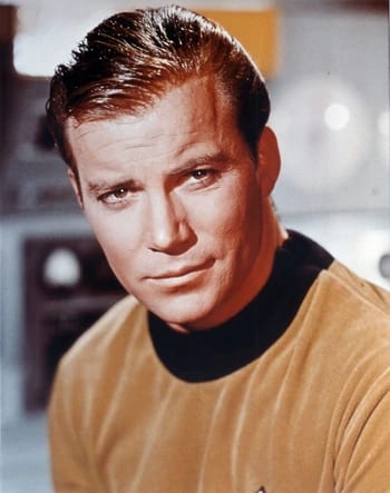 James T. Kirk seated in the command chair of the original Enterprise.