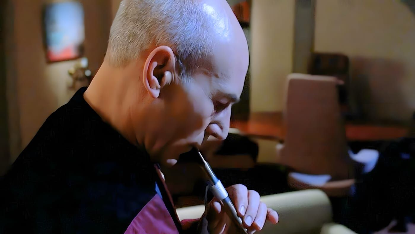 Jean-Luc Picard playing the Ressikan flute in his ready room aboard the USS Enterprise-D.