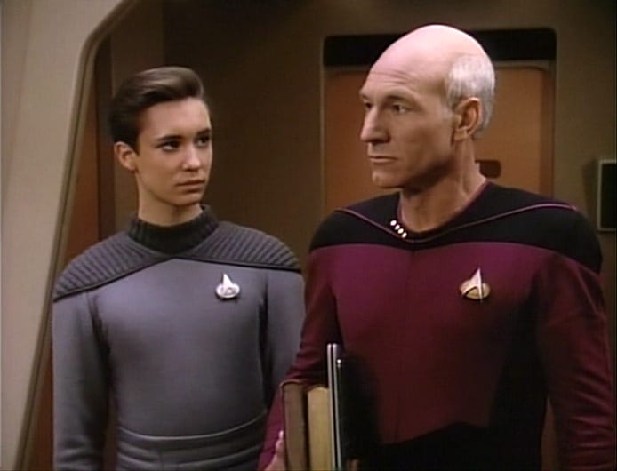 Wesley Crusher standing beside Jean-Luc Picard aboard the Enterprise-D.